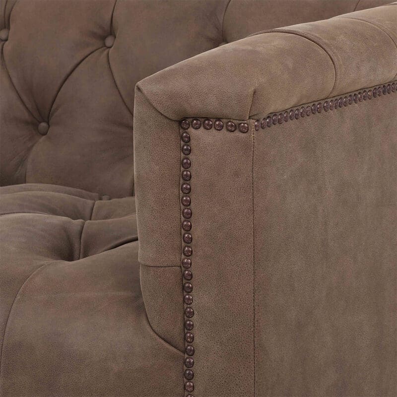 Luxurious brown tufted sofa with nailhead trim, perfect for stylish and comfortable living spaces.