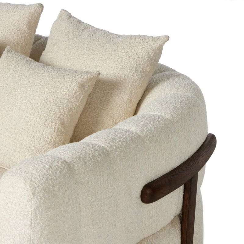 Stylish modern sofa with plush off-white upholstery and elegant wooden arms for cozy living spaces.