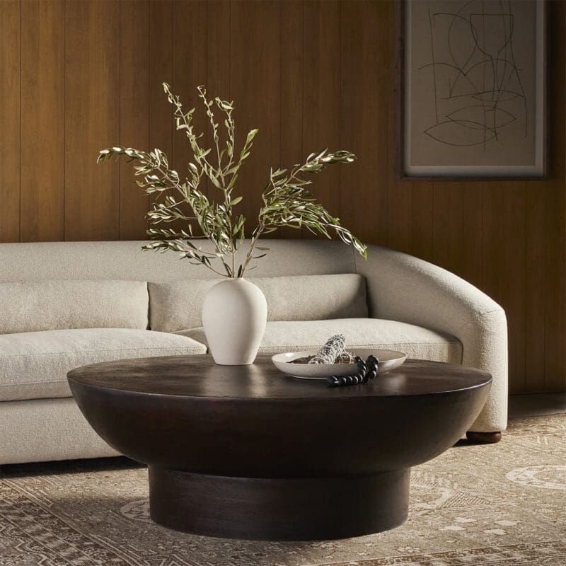 Stylish minimalist living room with dark wood coffee table, light sofa, and decorative accents.