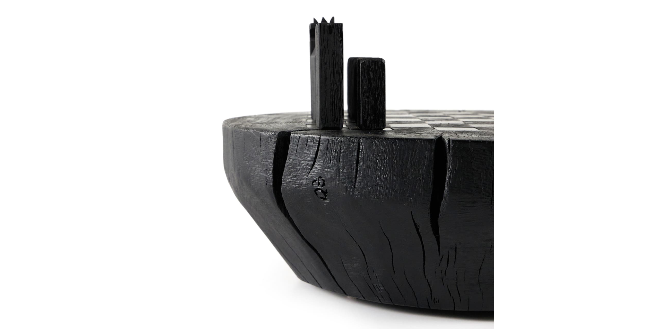 Contemporary black wood coffee table with sculptural design and dynamic upright elements.