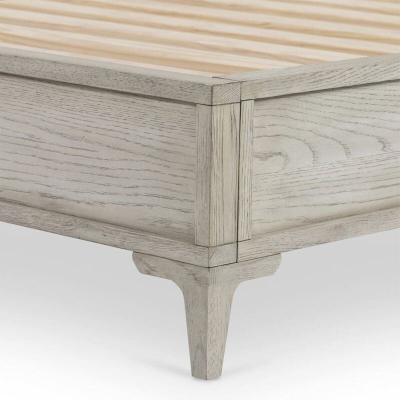 Elegant wooden platform bed corner with natural grain, precise joint, and stylish tapered legs.