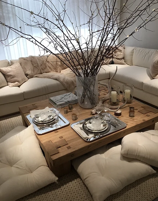 Cozy living room with rustic coffee table, elegant decor, and inviting plush seating.