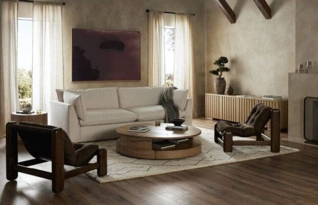 Cozy modern living room with earthy tones, artistic wall art, and inviting lounge chairs.
