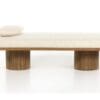Minimalist bench with plush cushion and wooden pedestals, perfect for modern interiors.