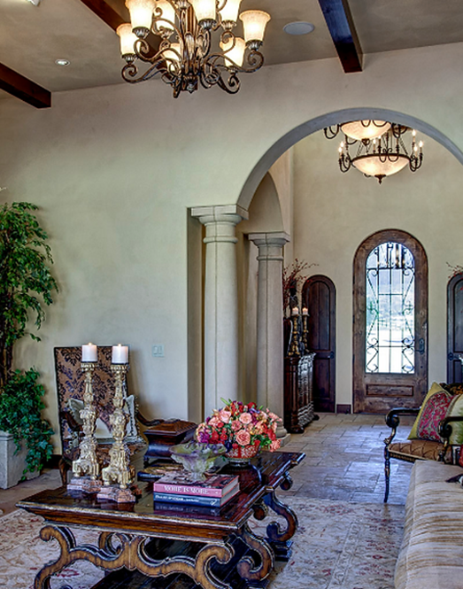 Elegant living space with high ceilings, dark wood accents, and cozy, inviting decor.