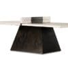 Minimalist industrial table with light concrete top and geometric dark base, featuring a central cut-out.