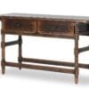 Rustic wooden table with elegant turned legs and functional drawers for versatile home decor.