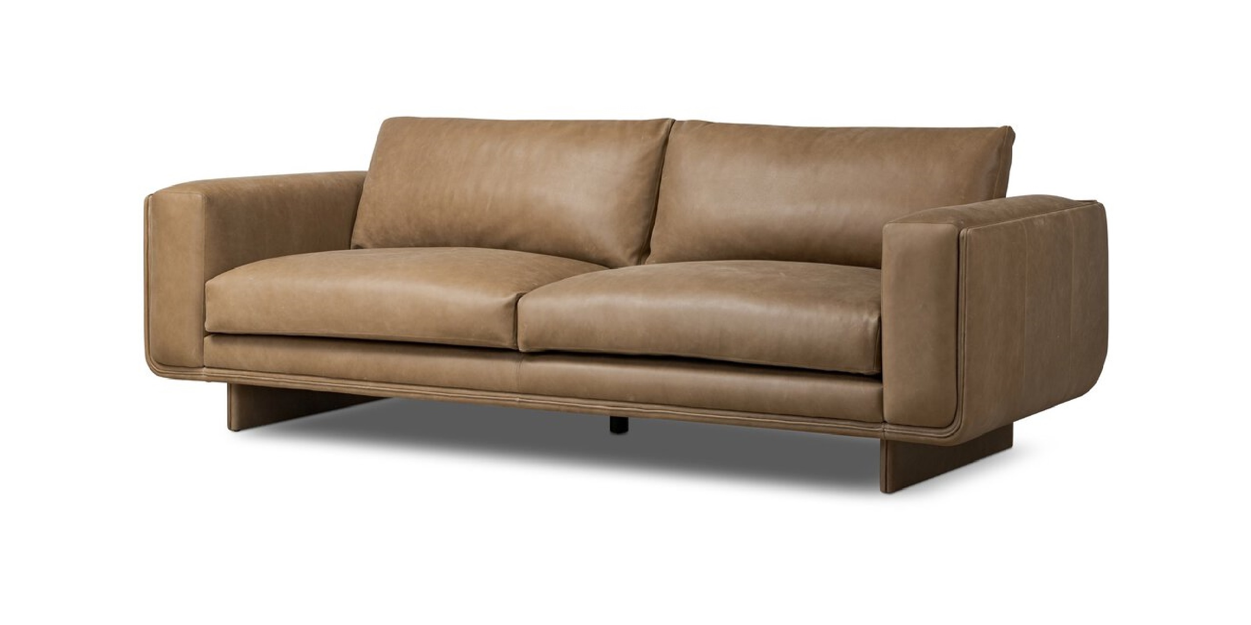 Contemporary tan leather sofa offering comfort and style for any modern living space.