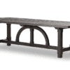 Durable wooden table with dark finish, geometric legs, and unique curved design for versatile elegance.