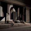 Elegant minimalist lounge featuring a rustic beige sofa and artistic geometric wall mural.