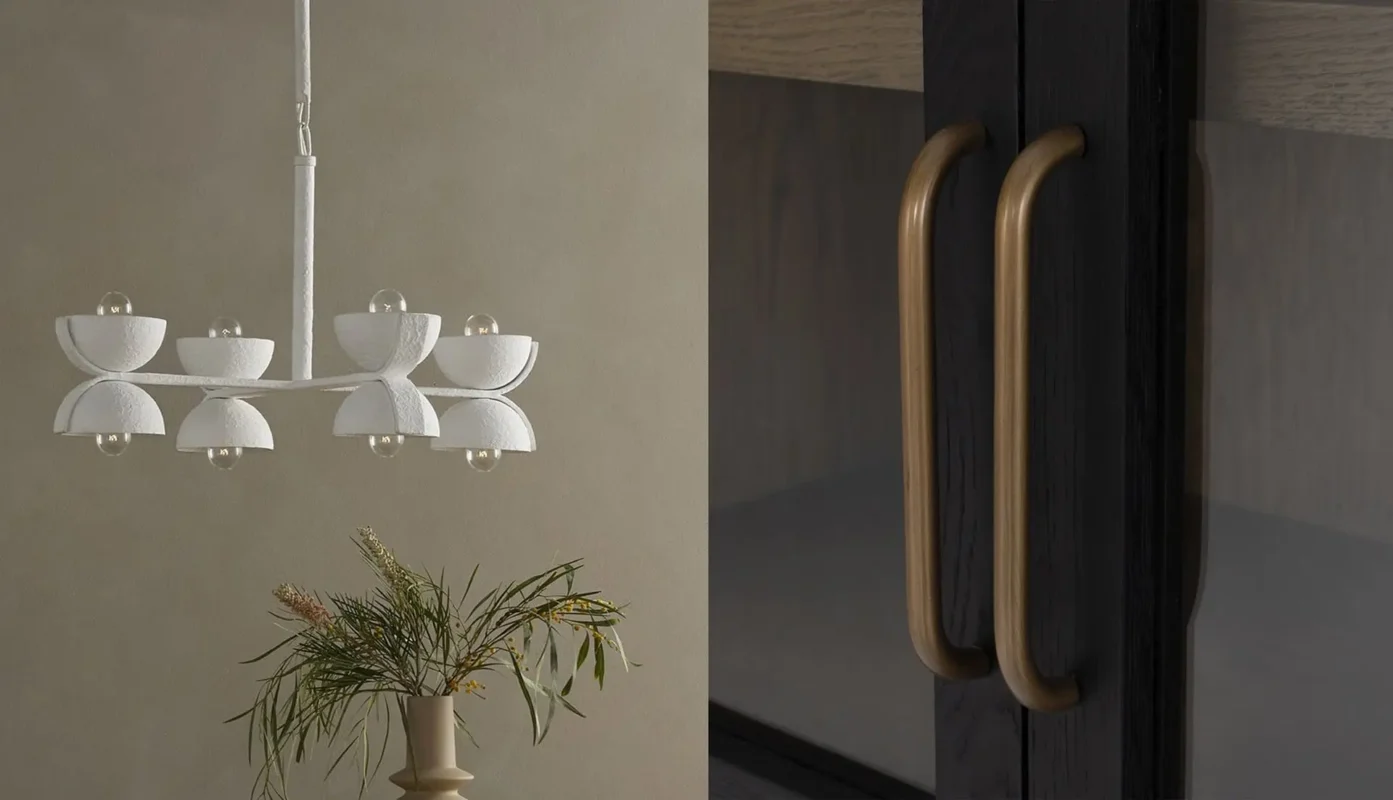 Elegant modern interior with minimalist chandelier, dark cabinet, and greenery for a sophisticated ambiance.