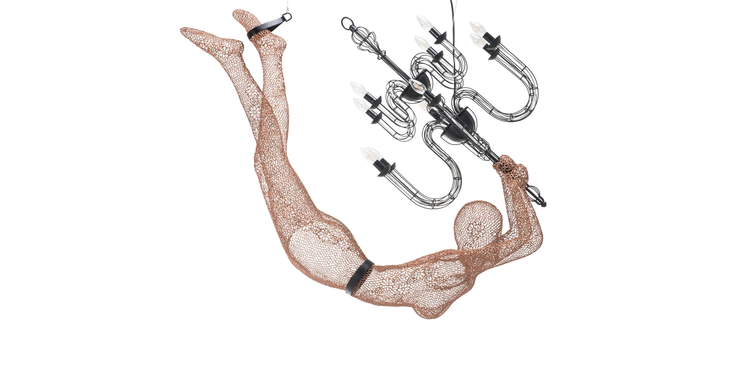 Dynamic wire mesh figure diving with a chandelier, blending human form and light in graceful elegance.