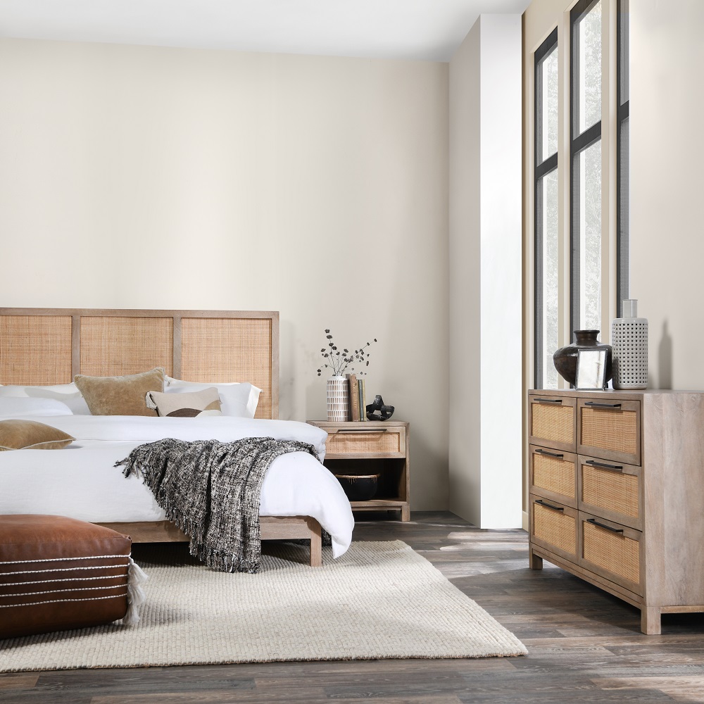 Cozy modern bedroom featuring natural textures, soft colors, and abundant natural light for relaxation.