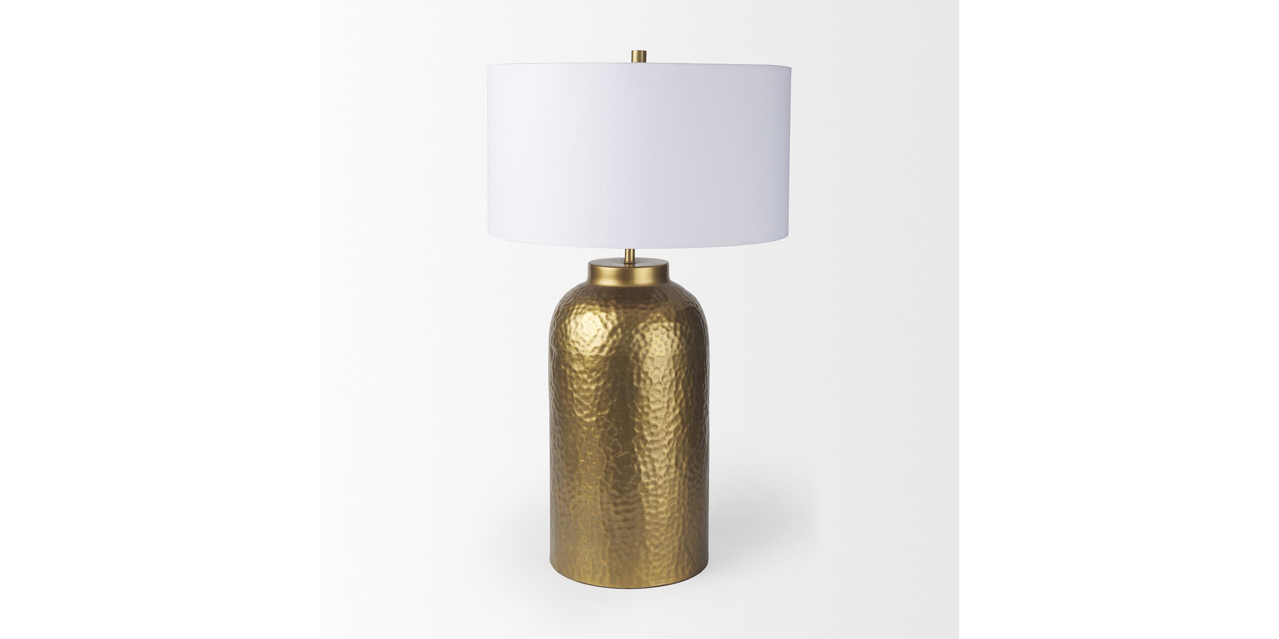 Stylish gold table lamp with textured base and white cylindrical shade for modern decor.