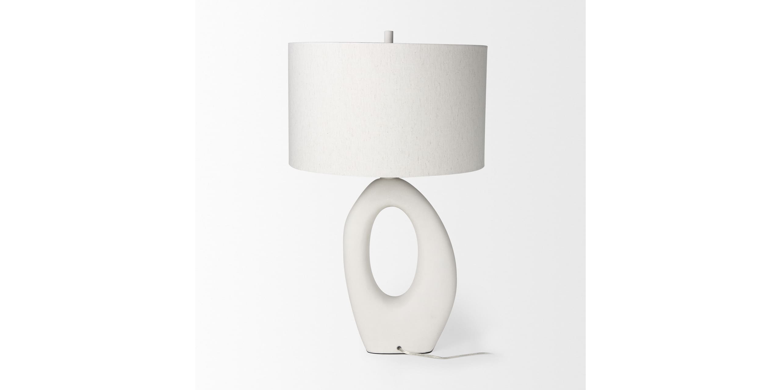 Sleek modern table lamp with soft fabric shade and sculptural base for elegant interiors.