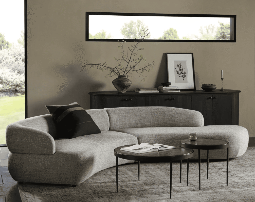 Close-up of high-quality, durable fabric on a stylish U-shaped sofa in a cozy living area.