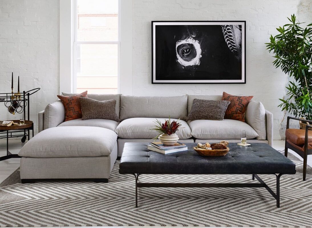 Elegant modular sectional sofa in a modern apartment living room, maximizing small space.