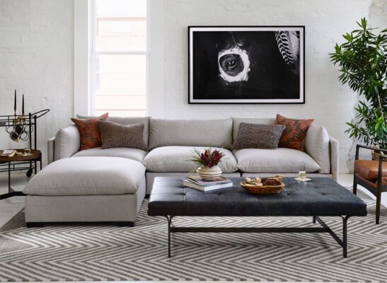 Elegant modular sectional sofa in a modern apartment living room, maximizing small space.